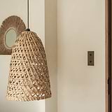Bronze Double 2x Vertical Toggle Switch mounted onto a cream wall with Wooden Wickered features complimenting the finished product. 