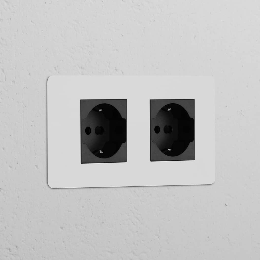 Double 2x Schuko/Bipasso Power Module in paintable black, featuring dual electrical sockets.