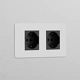 Double 2x Schuko/Bipasso Power Module in paintable black, featuring dual electrical sockets.