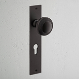 Poplar Long Plate Sprung Door Knob & Euro Lock Bronze Finish on White Background at an Angle