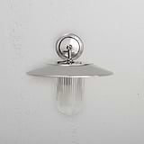 Medium Kensington Wall Light with fluted ribbed glass shade and polished nickel base, mounted on a white wall.