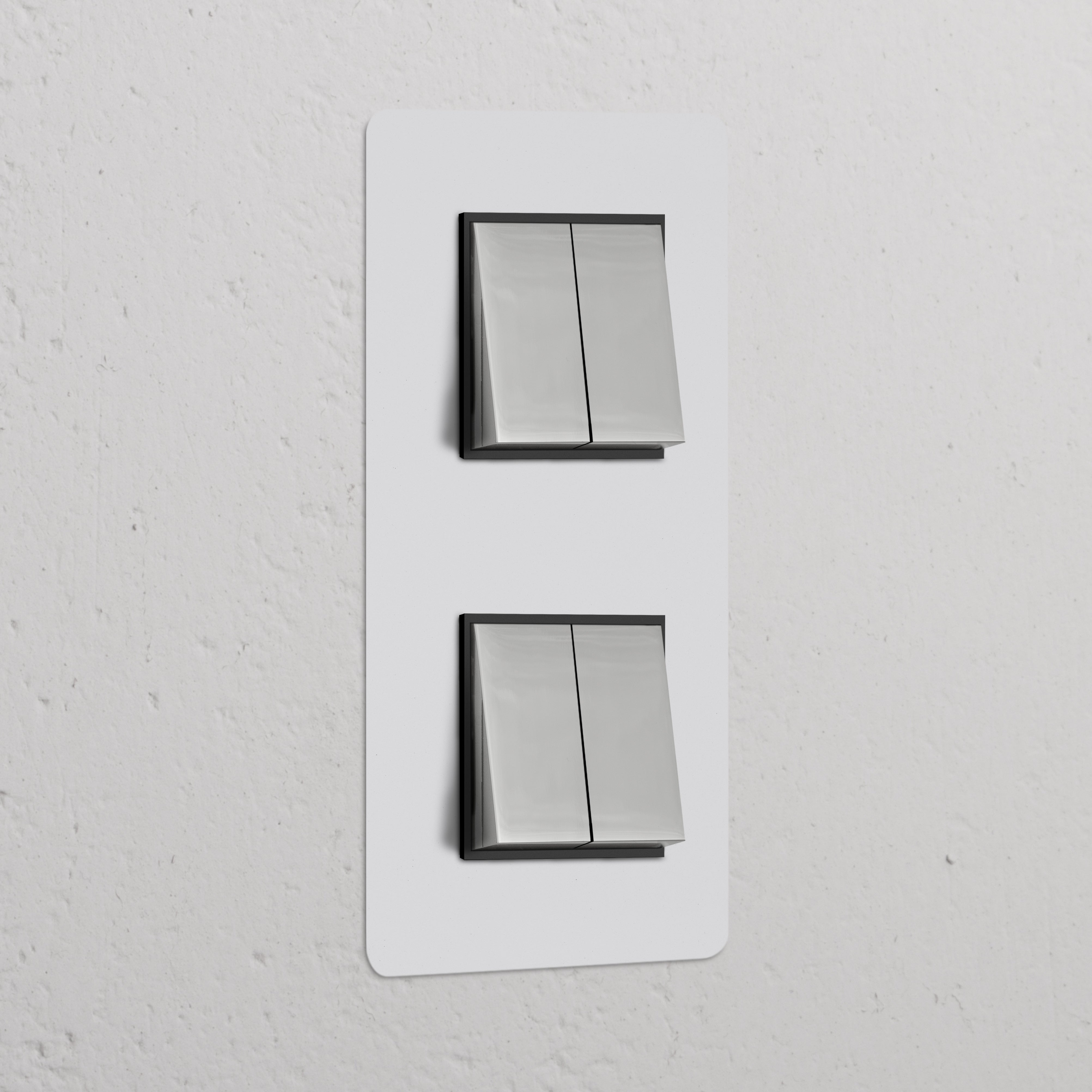 Double 4x Vertical Rocker Switch in Paintable Polished Nickel Black on a textured white wall.