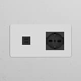 Paintable black double socket with Schuko/Bipasso module and dual 30W USB ports for versatile power access.