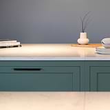 Bronze Oxford Furniture Handle 384mm fitted to an undercounter kitchen unit draw. Front on view showing two handles on two green draws with white stone coutner top. 