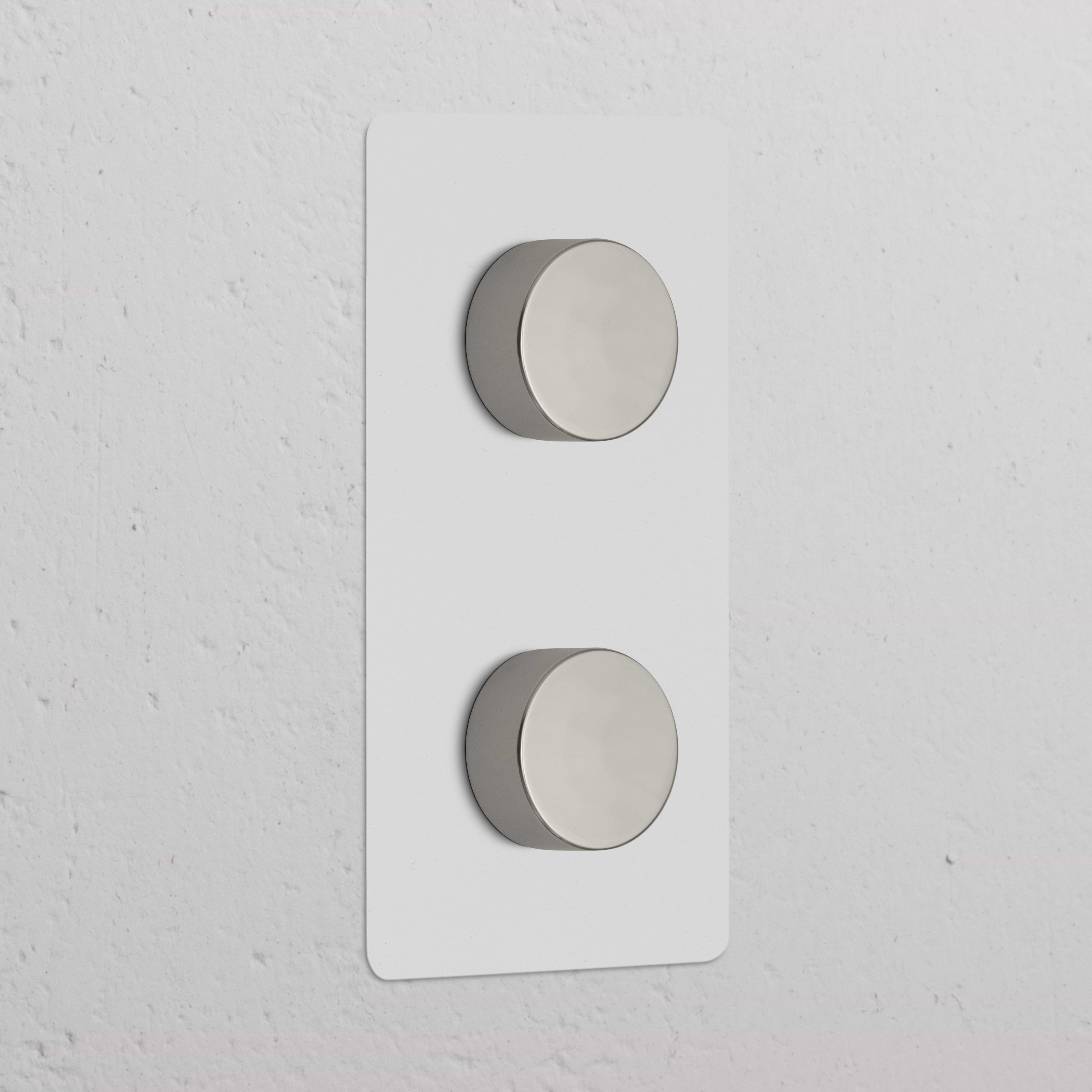Double 2x Vertical Multiway Dimmer Switch with two polished nickel knobs on a paintable plate, wall-mounted.