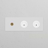 Triple Toggle Switch with 2 Swiss Type J Modules in paintable antique brass on a white panel.