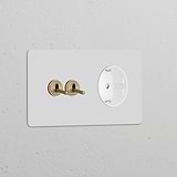 Paintable antique brass double toggle switch with Schuko Type F module on a white background.