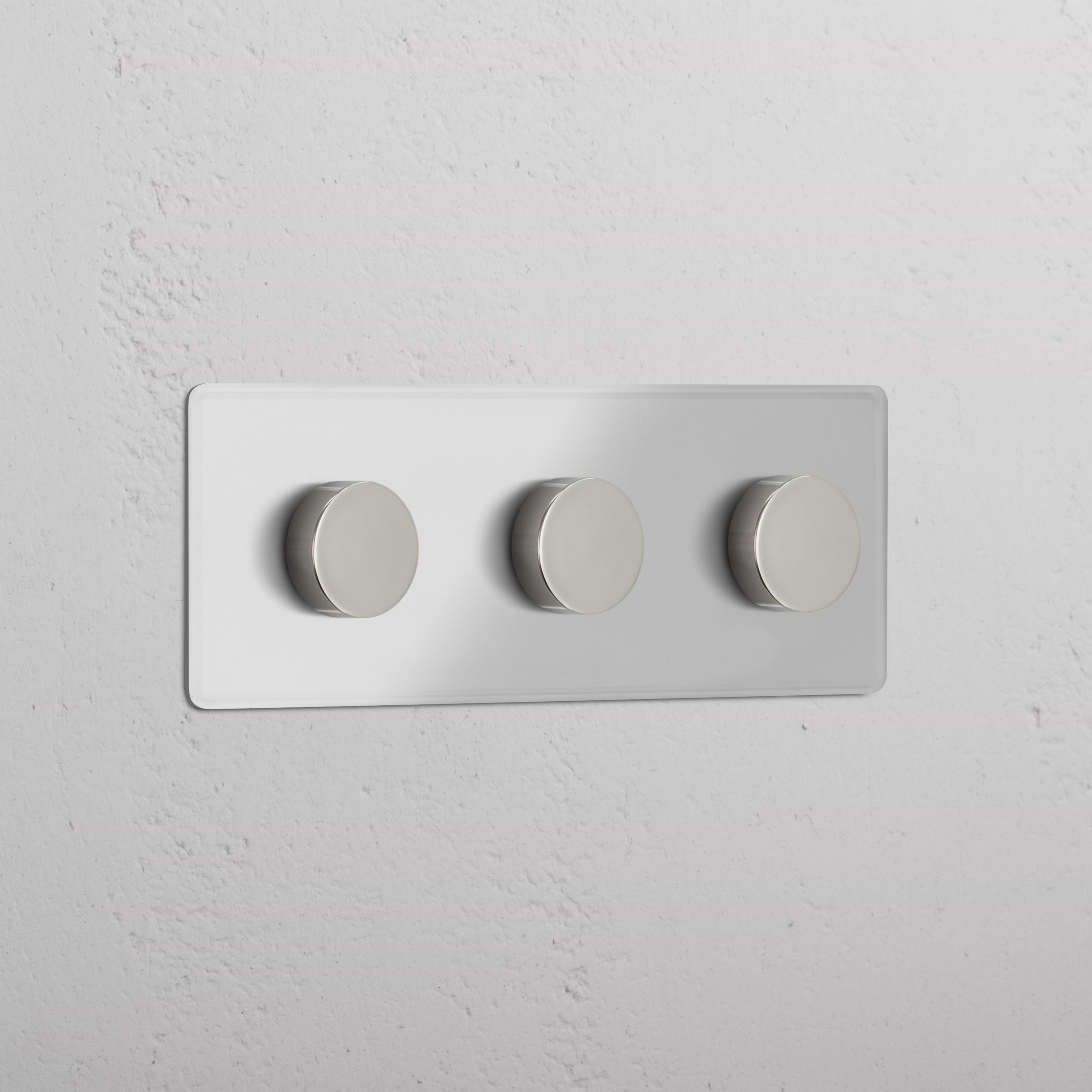 Triple 3x Multiway Dimmer Switch with three clear polished nickel knobs on a white wall.