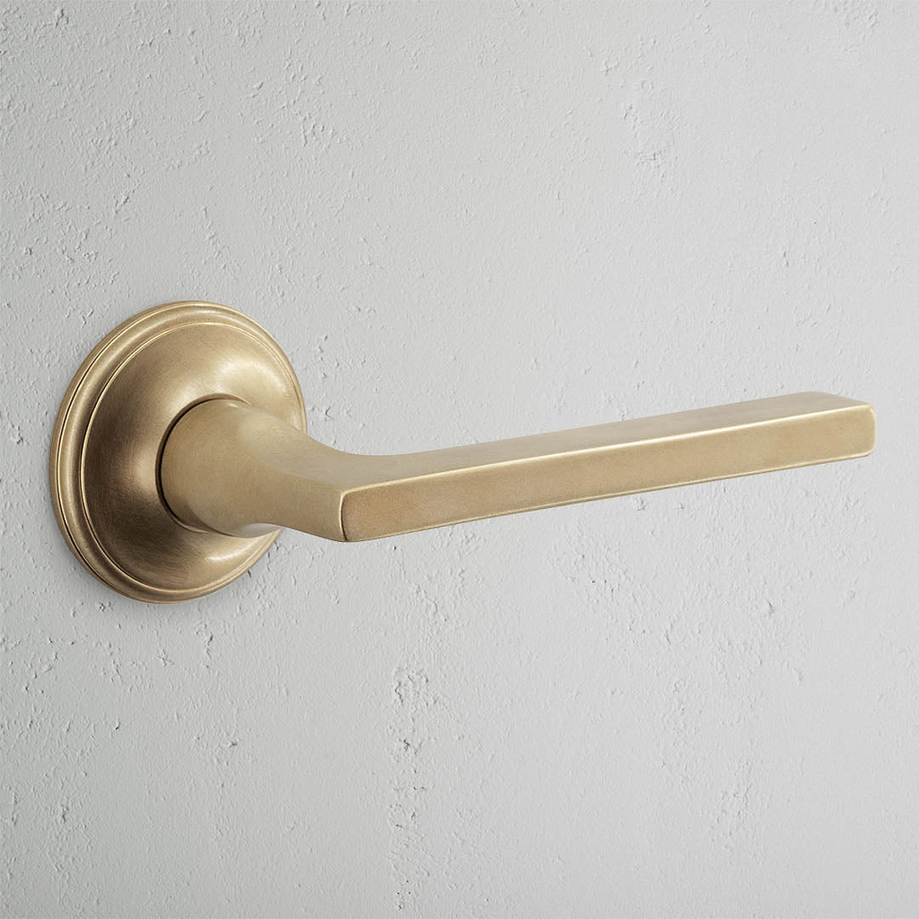 Clayton Unsprung Door Handle Antique Brass Finish on White Background 