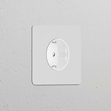 Paintable white Single Schuko Type F Power Module for electrical sockets blends into a light grey wall.