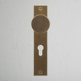 Onslow Long Plate Sprung Door Knob & Euro Lock Antique Brass Finish on White Background right Facing Front View