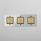 Six-Position Triple Rocker Switch in Clear Antique Brass Black - Comprehensive Lighting Accessory on White Background