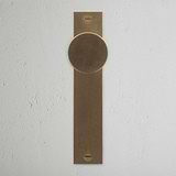 Onslow Long Plate Sprung Door Knob Antique Brass Finish on White Background right Facing Front View
