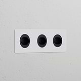 Triple 3x Swiss Type J paintable black power modules in a sleek, round design for seamless wall integration.