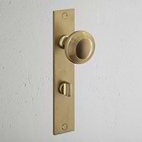 Poplar Long Plate Sprung Door Knob & Thumbturn Antique Brass Finish on White Background at an Angle