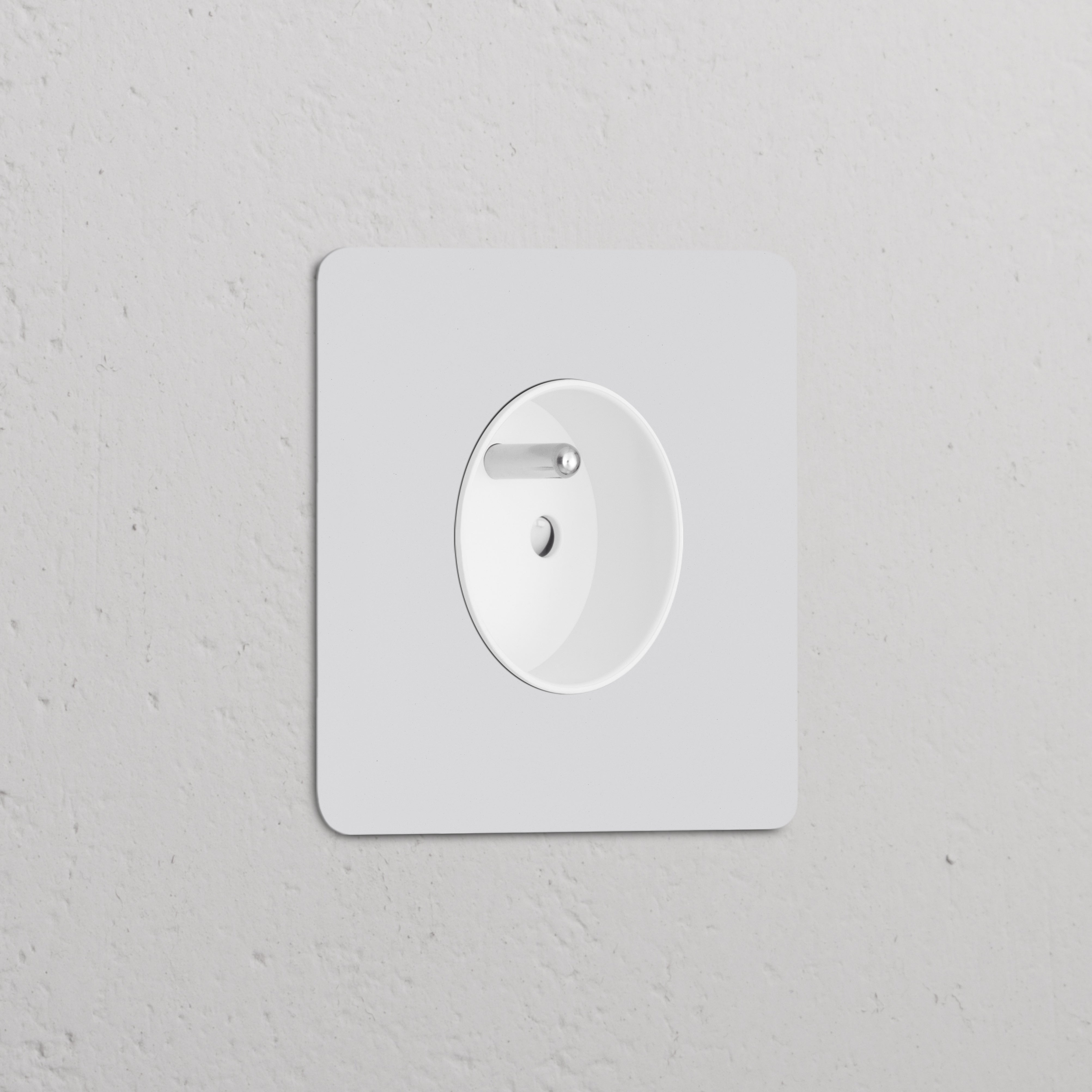 A round, paintable white Single French/Belgian Type E power module socket on a textured white wall.