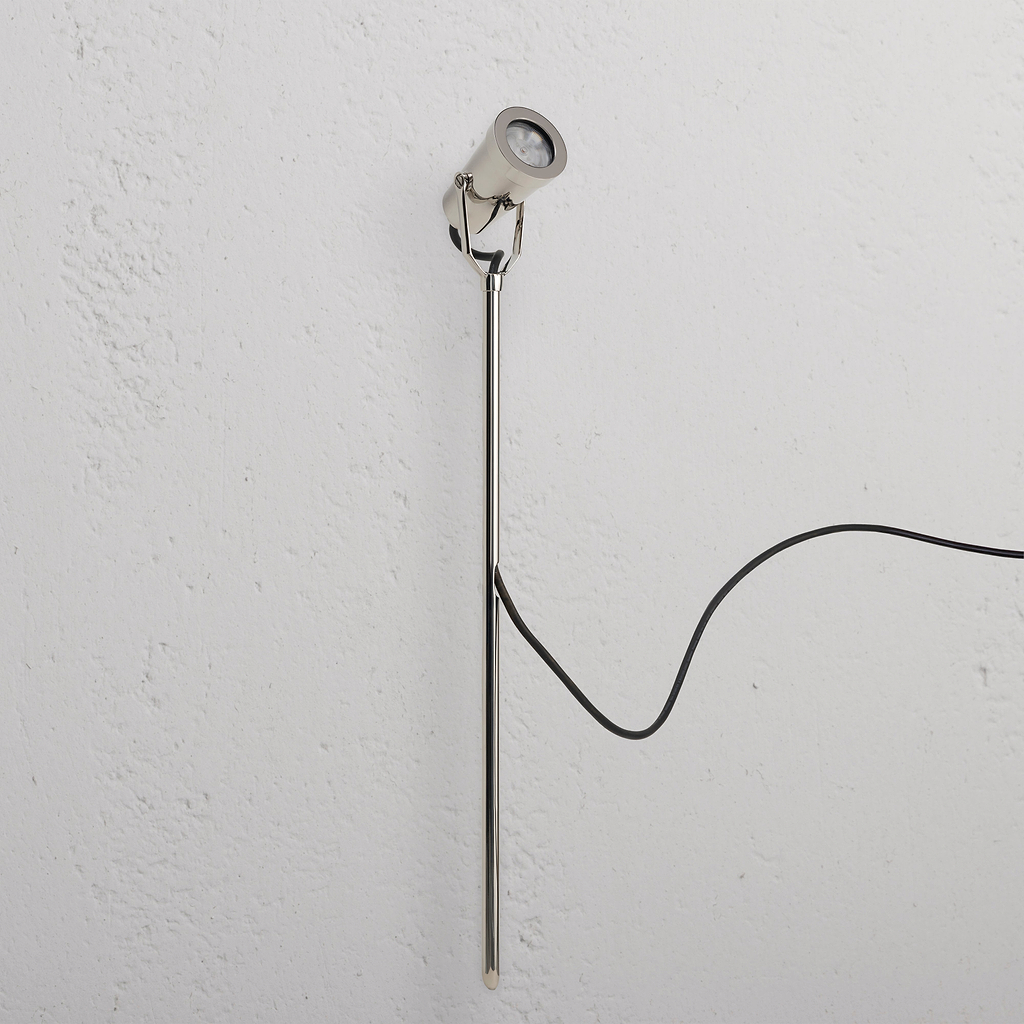 Cambridge Ground Spotlight 24V in polished nickel, a sleek outdoor spotlight with black power cord attached.