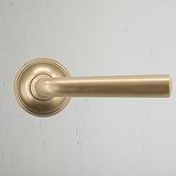 Apsley Sprung Door Handle Antique Brass Finish on White Background Front Facing