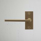 Clayton Short Plate Fixed Door Handle Antique Brass Finish on White Background right Facing Front View