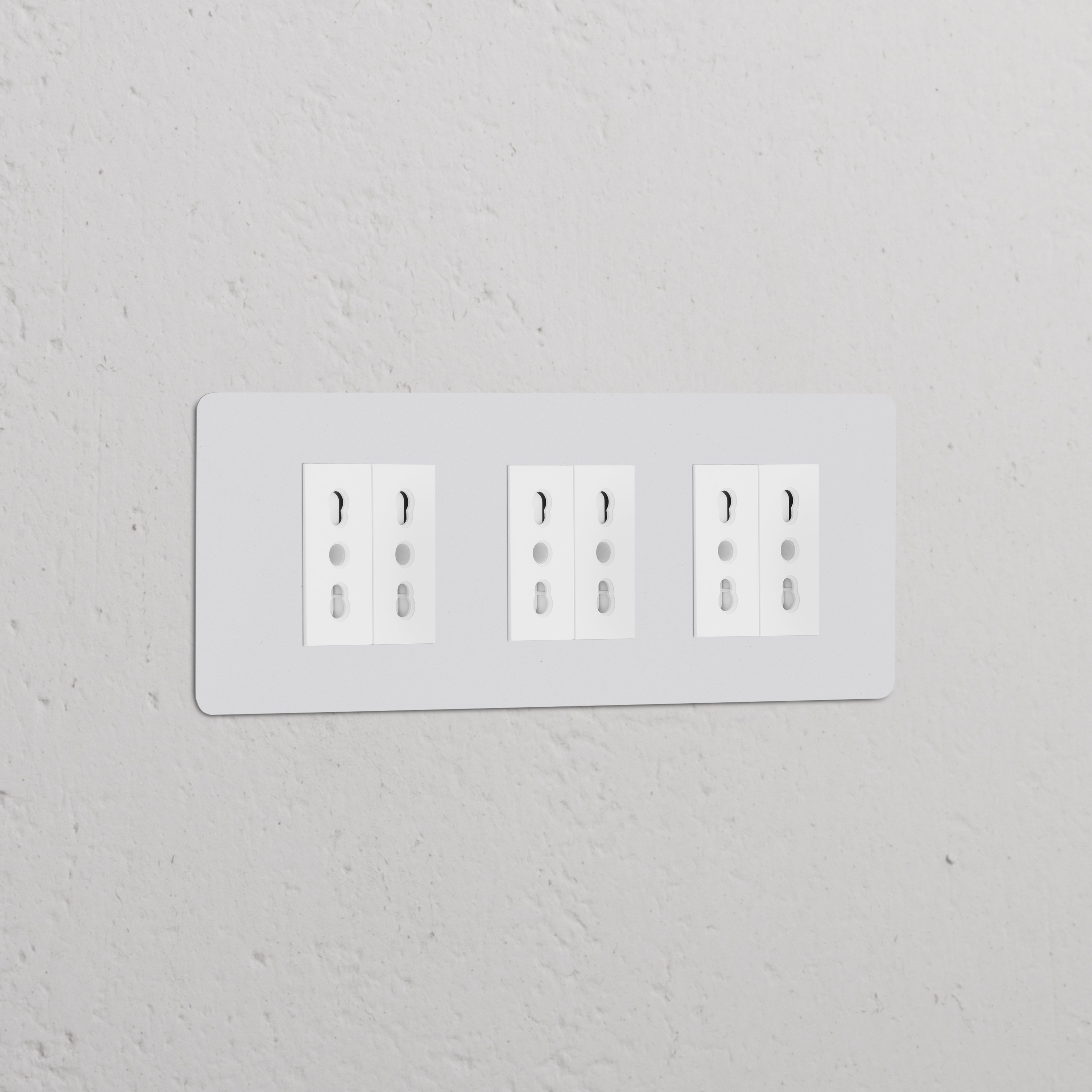 Triple 6x Bipasso Power Module in paintable white with three sockets, blends into the wall for a seamless look.