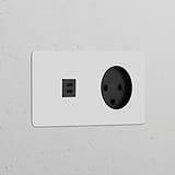 Round black Danish Type K module, Double USB 30W sockets, paintable finish for versatile décor matching.