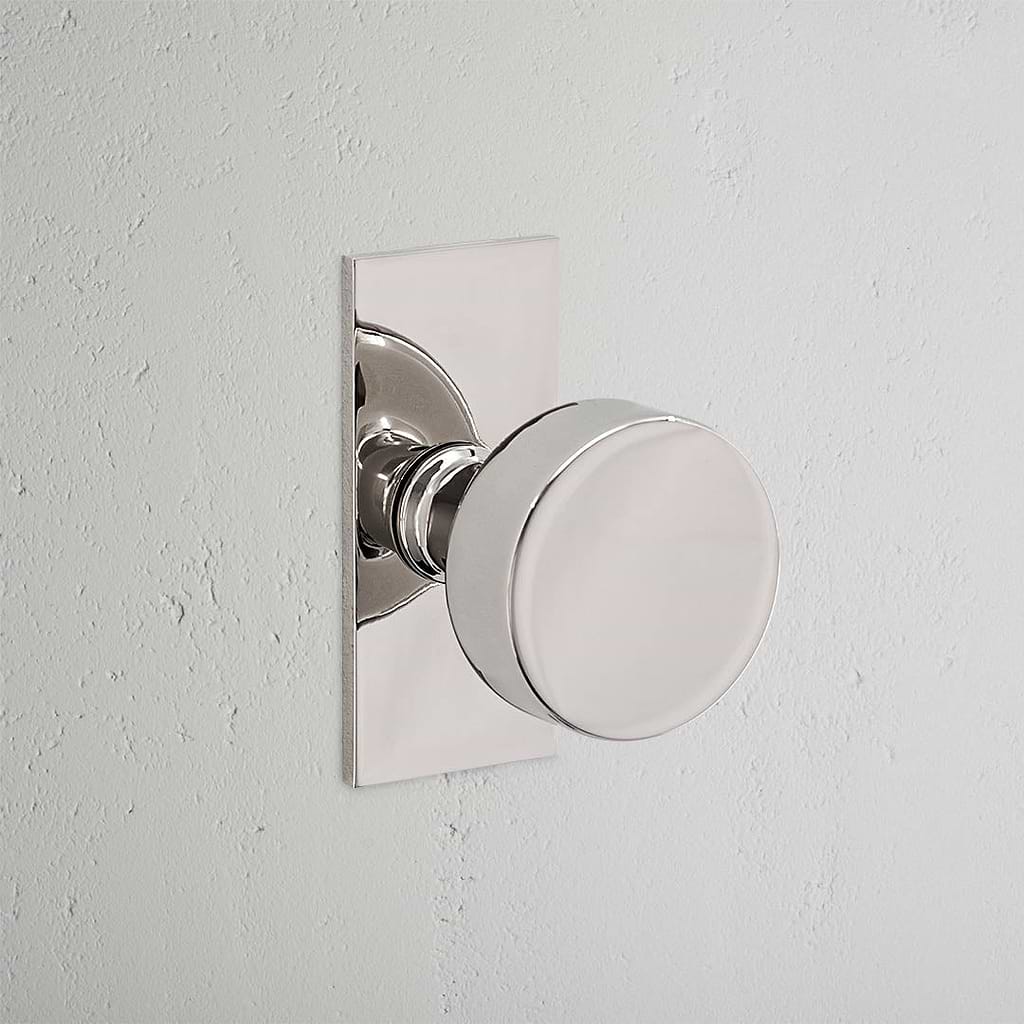 Onslow Short Plate Sprung Door Knob Polished Nickel Finish on White Background