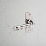 Digby Short Plate Sprung Door Handle Polished Nickel Finish on White Background at an Angle