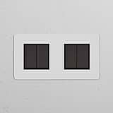Double 4x Rocker Switch in paintable bronze black finish, designed for seamless integration with wall decor.