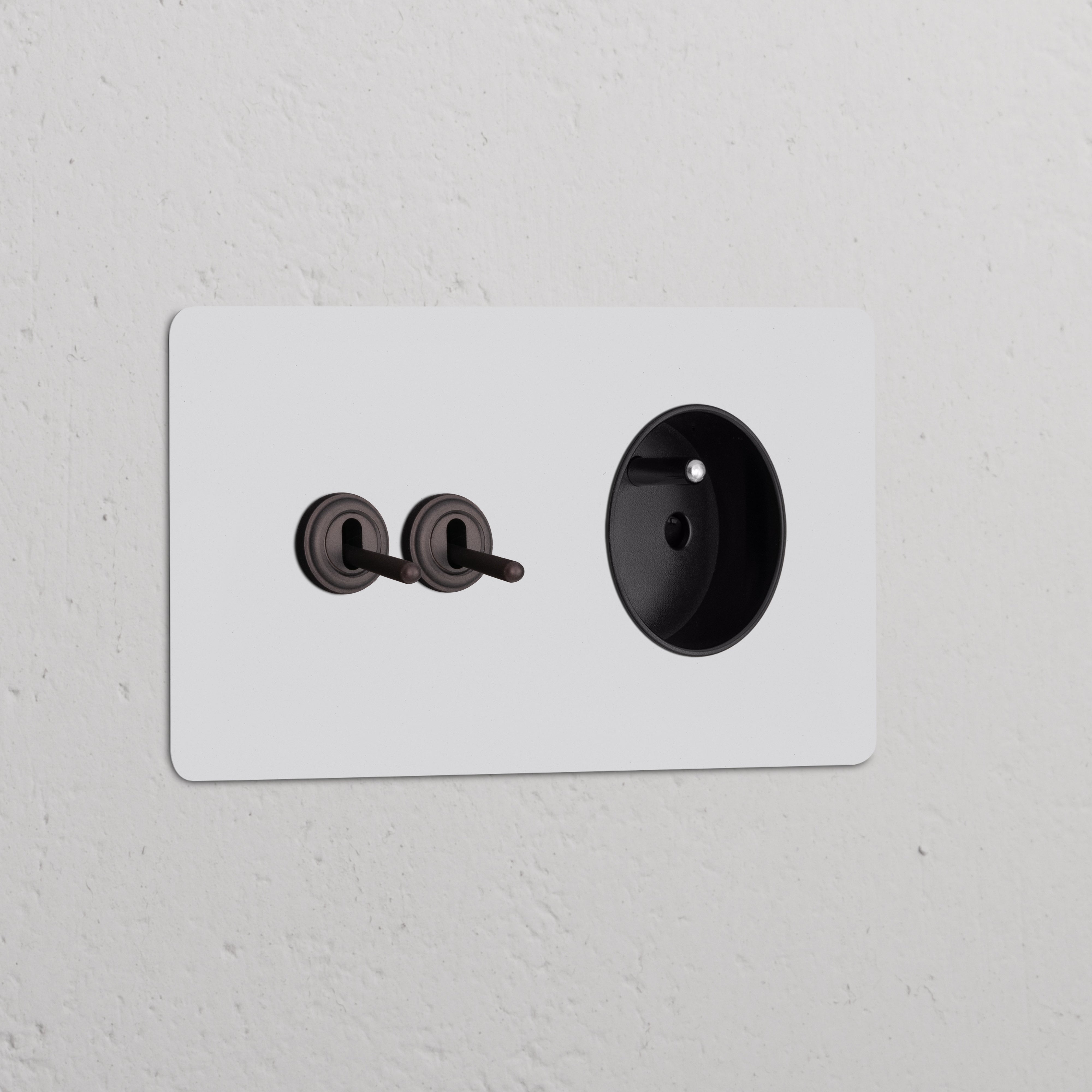 Double toggle switch and French/Belgian Type E socket in paintable bronze black finish.