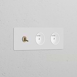 Triple sockets with triple toggle switch and 2 Type E modules in paintable antique brass white on a textured wall.