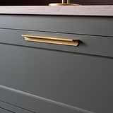 Antique Brass Oxford Furniture Handle 224mm fitted to a dark grey furniture drawer with white marble stone top. 