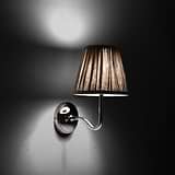 Medium Malvern Wall Light in Natural Beige at an angle and turned on at night