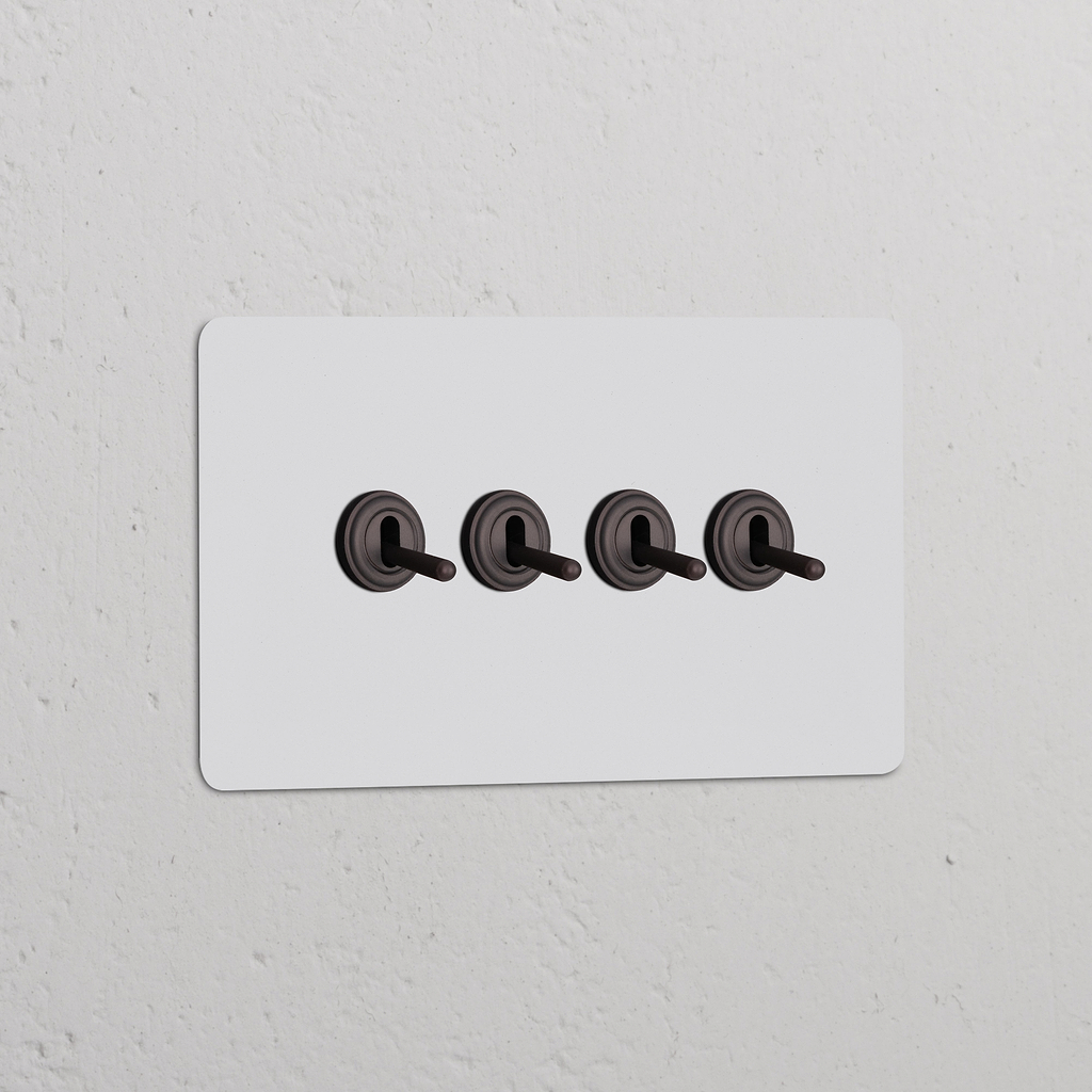 Double 4x Toggle Switch in Paintable Bronze, with four toggles on a rectangular panel for double switches & dimmers.