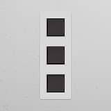 Triple 3x Vertical Rocker Switch in Paintable Bronze Black finish with three black buttons on a sleek rectangular panel.
