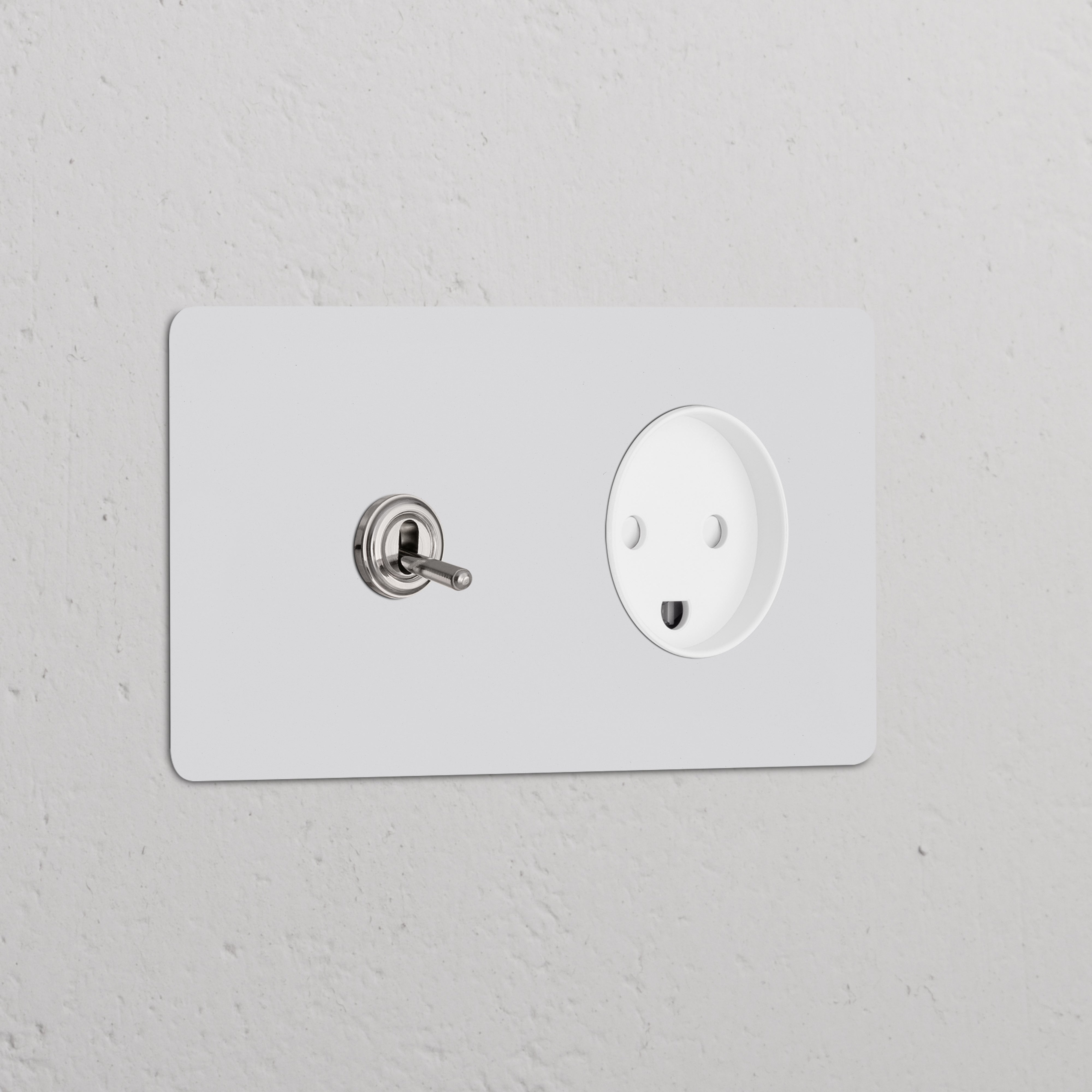 Double Toggle Switch with Danish Type K Power Module in paintable polished nickel, on a white textured wall.