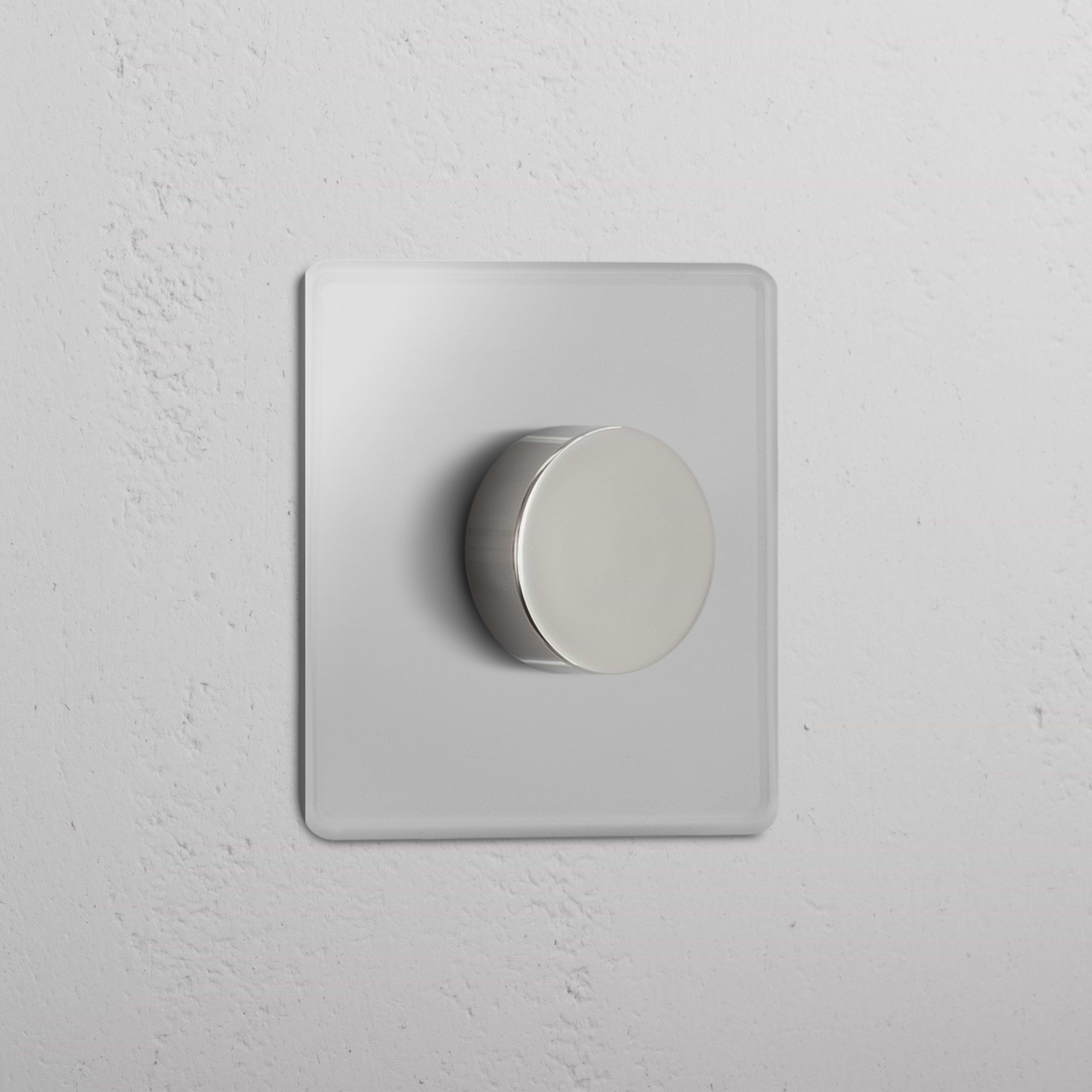 Clear Polished Nickel Single Multiway Dimmer Switch on a square wall plate, mounted on a white wall.