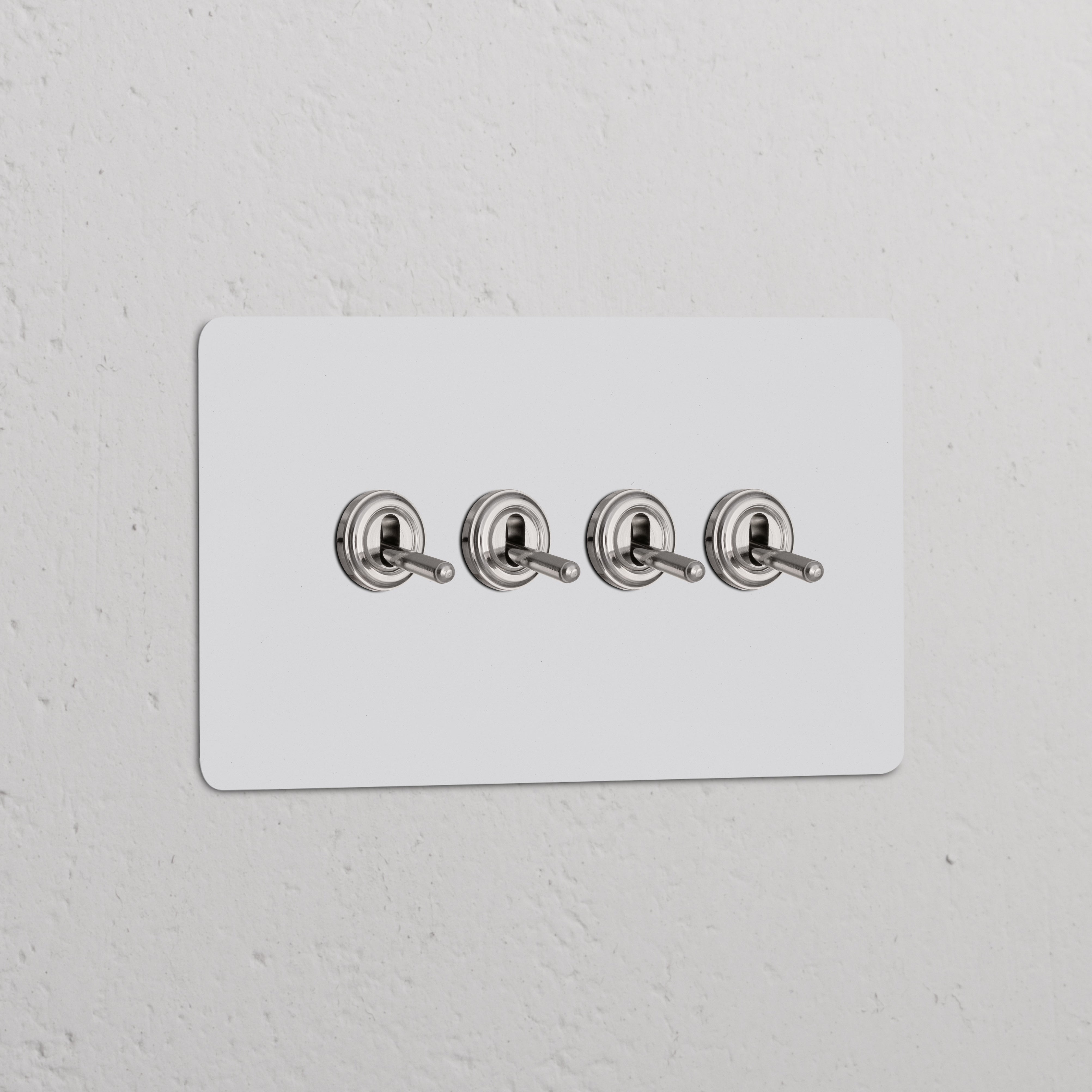 Double 4x Toggle Switch in paintable polished nickel finish on a white panel for switches and dimmers.