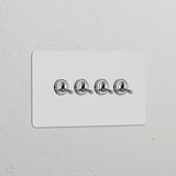 Double 4x Toggle Switch in paintable polished nickel finish on a white panel for switches and dimmers.