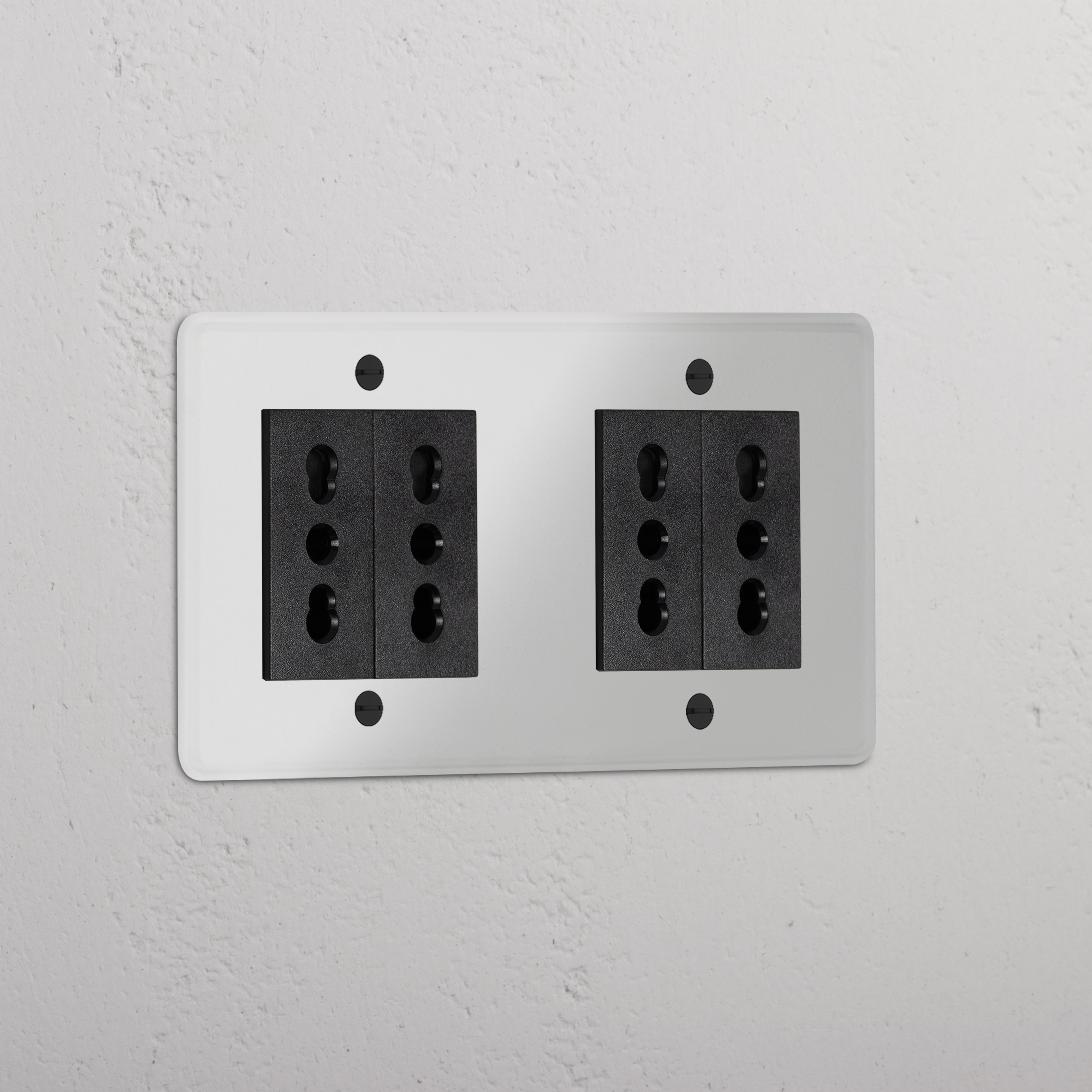 Clear Black Double 4x Bipasso Module on a white wall for dual black sockets and modules.