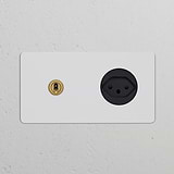 Double toggle switch and Swiss Type J power module in paintable antique brass black on a white wall.