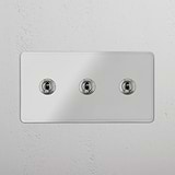 Functional Triple Toggle Switch in Clear Polished Nickel for Light Control on White Background