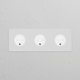 Triple 3x Danish Type K power module, round, paintable white sockets on a light gray wall.