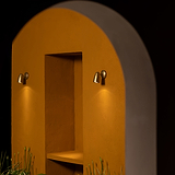 Antique Brass Ealing Flush Spotlight wall-mounted illuminating light downwards with one each side of a built in stone wall shelfing space