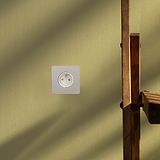 Single French Power Module Round in Polished Nickel White on a green wall beside a wooden ladder.