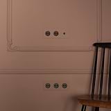 Triple Toggle Switch + 2x Type E Power Module in Paintable Bronze Black on a decorative wall.