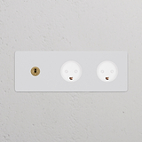 Triple toggle switch and dual Danish Type K power module in paintable antique brass white on a textured wall.