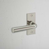 Apsley Short Plate Sprung Door Handle Polished Nickel Finish on White Background at an Angle