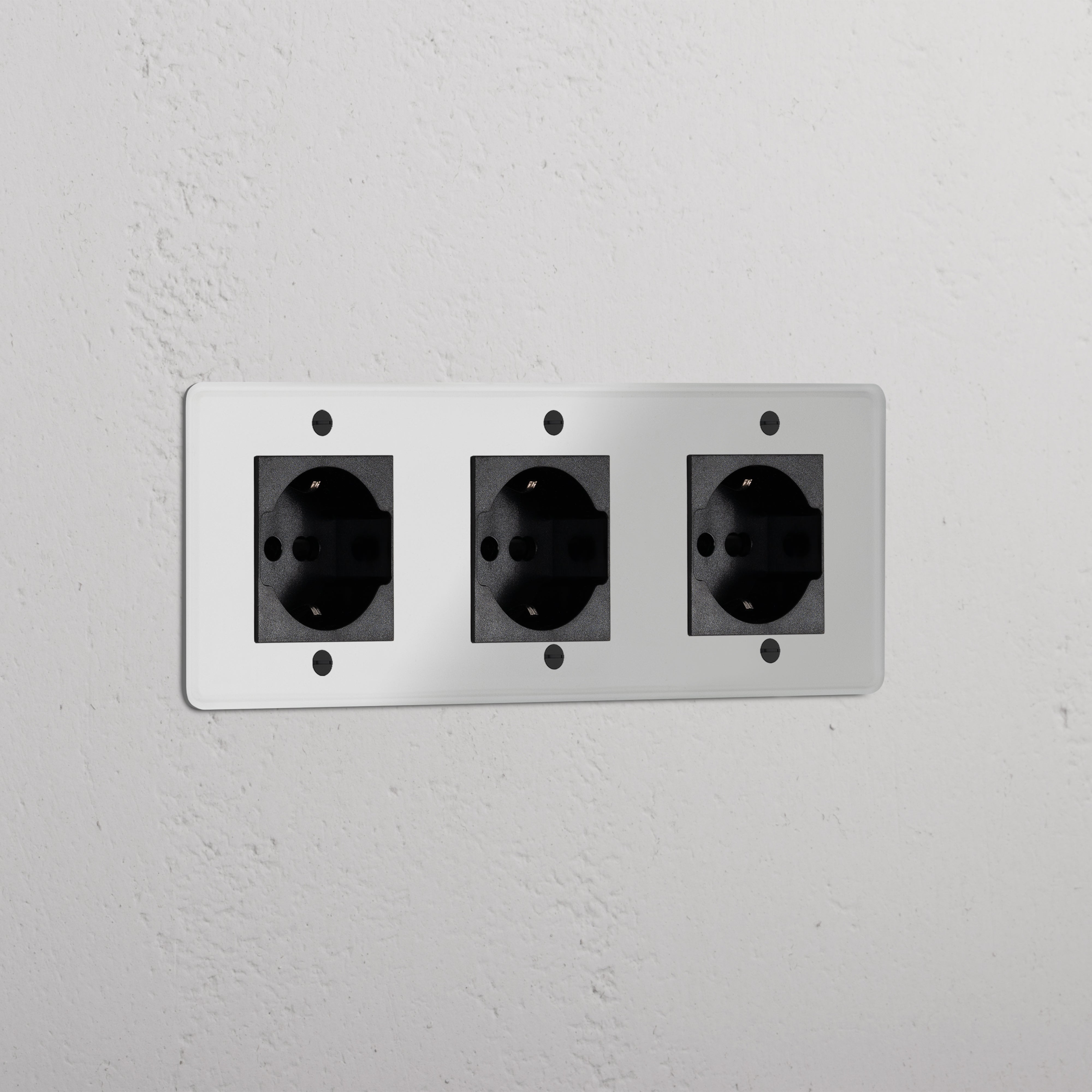 Triple 3x Schuko/Bipasso Module in clear black, showing three neatly aligned electrical sockets.