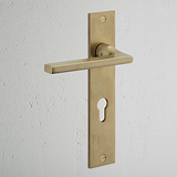 Clayton Long Plate Sprung Door Handle & Euro Lock Antique Brass Finish on White Background at an Angle