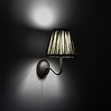 Small Malvern Wall Light in Deep Green at an angle and turned on at night
